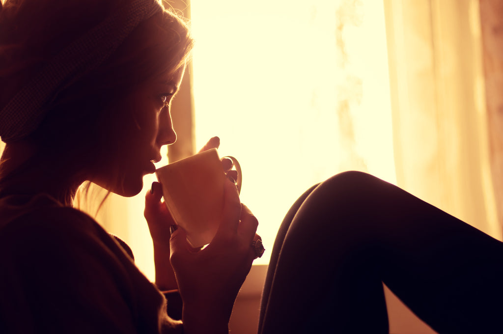 lady drinking mug of steaming Noble House Coffee available from Noble House Prepared