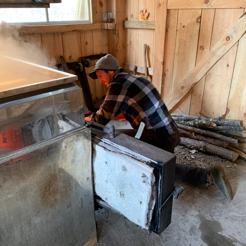 feeding the fire for the maple syrup evaporator