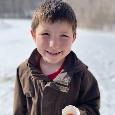 tasting the maple syrup at The Sugar Barn