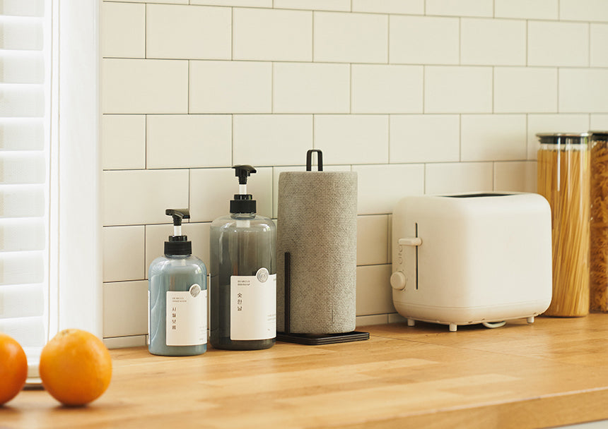 Dearcus handsoap series displayed on kitchen countertop with oranges.