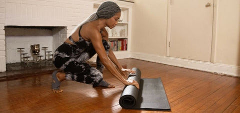 lady getting ready for mat exercise at home