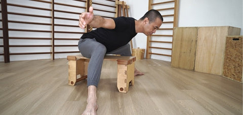 Seated hip hinge demonstrated by Michel Velasco