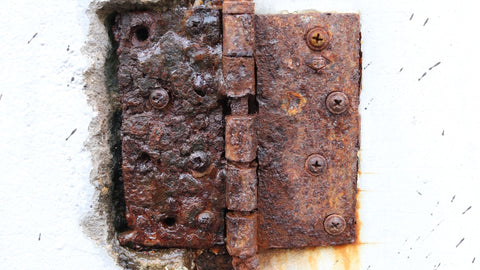 Rusty door hinge representing an old, unmaintained joints of the body
