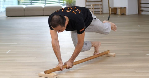 balance training on a long parallel bar on the floor