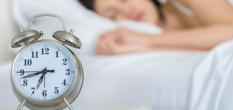 photo of lady sleeping with alarm clock