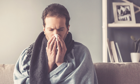 man clearing his nose and getting sick more often from overtraining