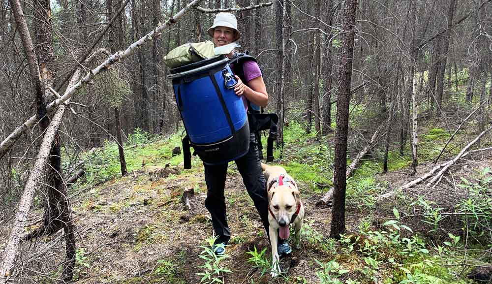 Edith MacHattie portaging with her dog 