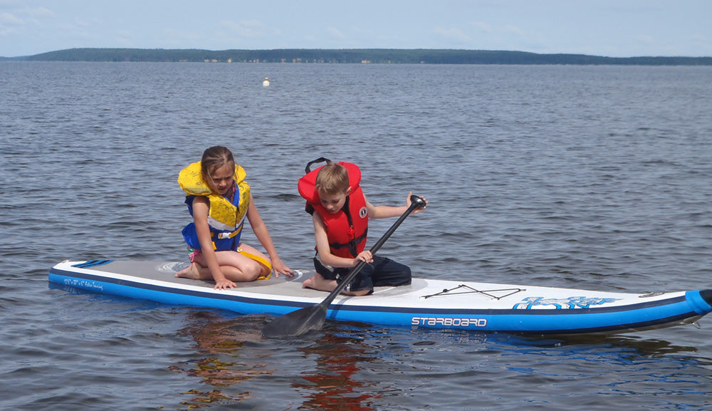 kids on a paddle board 