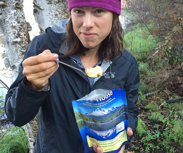 woman eating backpacker meal
