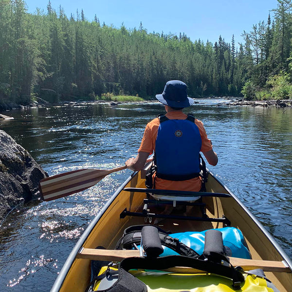 paddler in a canoe looking at rapids