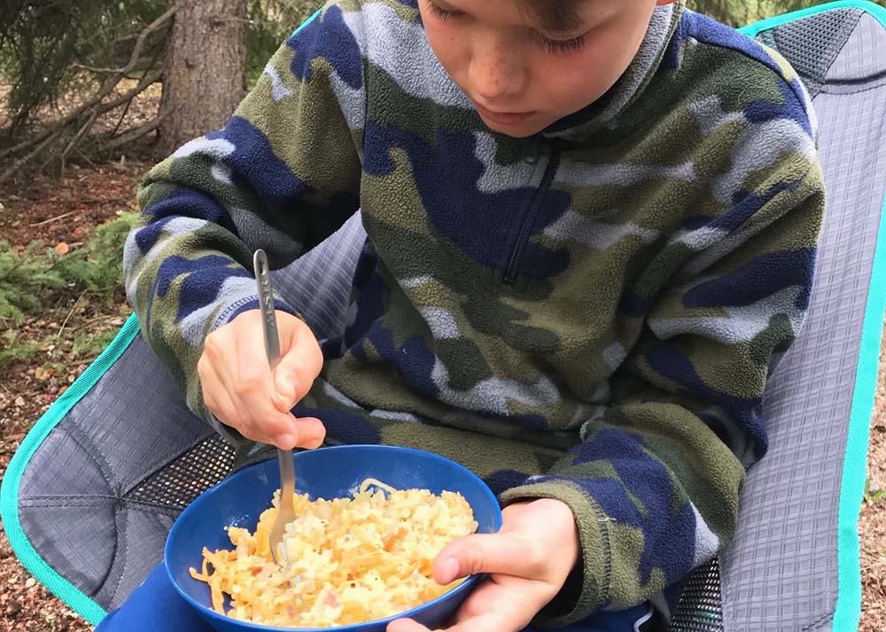 kid eating hashbrowns on trip 