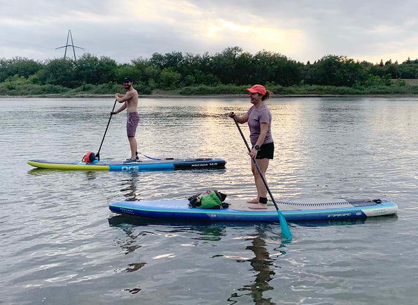 people paddle boarding on the Saskatchewan River