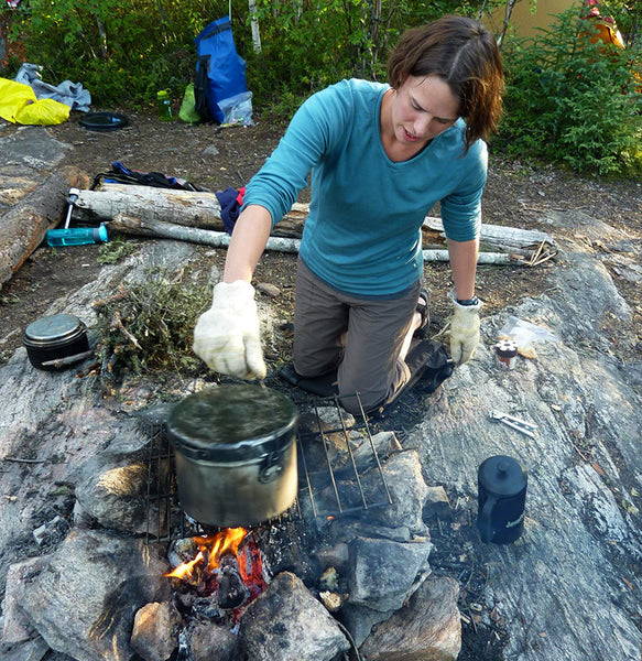 making camp popcorn over fire