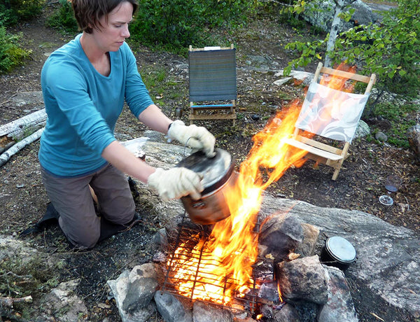 making camp popcorn over fire