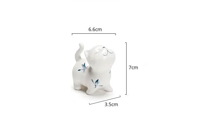 Petite Butterfly Orchid Porcelain by Allthingscurated is handmade with exquisite craftsmanship. Featuring beautiful, hand-painted blue butterfly orchids on white porcelain, the dainty design exudes an elegant charm and a touch of playfulness with its naughty and oh-so-cute expression. Small yet exquisite, it will charm any cat lovers and bring joy to any room.