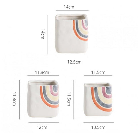 Biba Ceramic Square Planter by Allthingscurated features hand-painted rainbow-like pattern on a creamy white background with a groovy and hippie vibe. Available in small, medium and large size. Small pot measures 11.5cm by 11.5cm or 4.5 inches by 4.5 inches. The medium pot measures 11.8cm by 11.8cm or 4.6 inches by 4.6 inches. The large pot measures 14cm by 14cm or 5.5 inches by 5.5 inches.