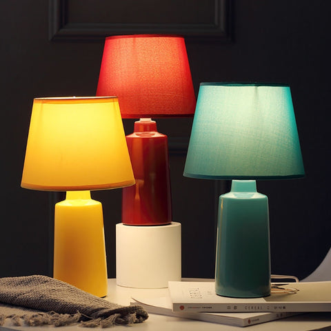 Burano Table Lamp by Allthingsucrated comes in 3 gorgeous colors in Red, Blue and Yellow.  The lamp base is made of ceramic and the lampshade of fabric.  Both the base and lampshade are of the same color.  This image is showing the lamps lighting effect with light switched on.