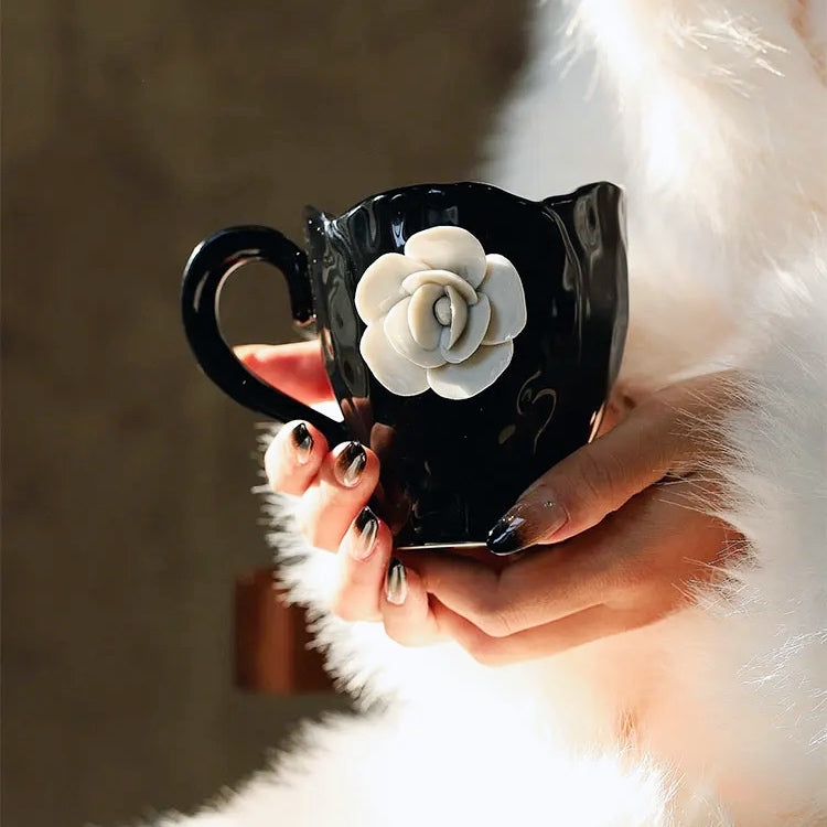 This Camellia Porcelain Cup Set / Mug by Allthingscurated features a single, significant bloom in a timeless black and white design that exudes sophistication. Its high fashion appeal makes it a perfect gift or impressive addition to your high-tea gatherings. Available as a mug or a cup set.