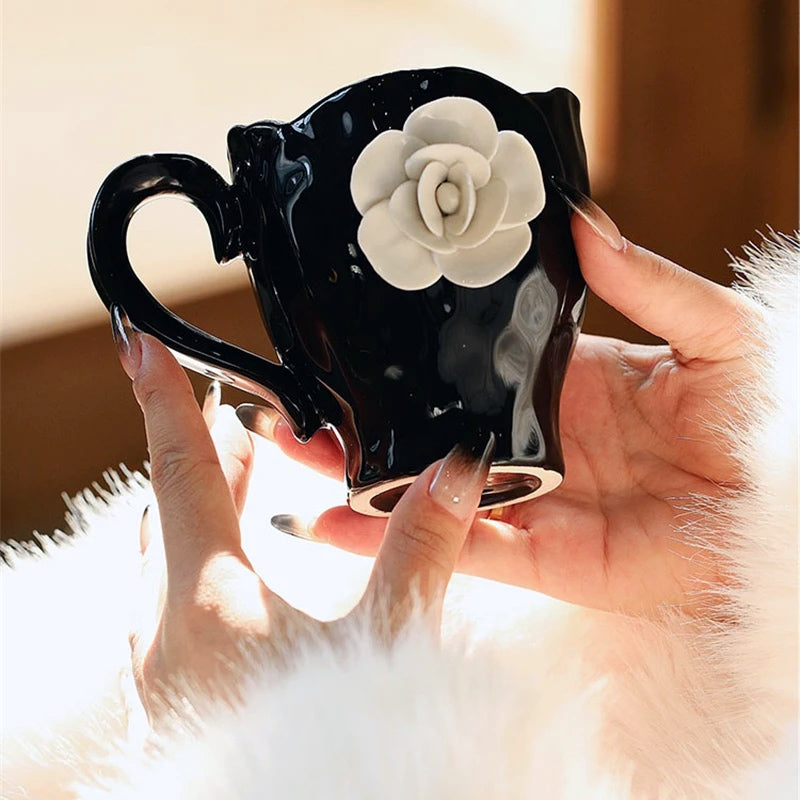 This Camellia Porcelain Cup Set / Mug by Allthingscurated features a single, significant bloom in a timeless black and white design that exudes sophistication. Its high fashion appeal makes it a perfect gift or impressive addition to your high-tea gatherings. Available as a mug or a cup set.