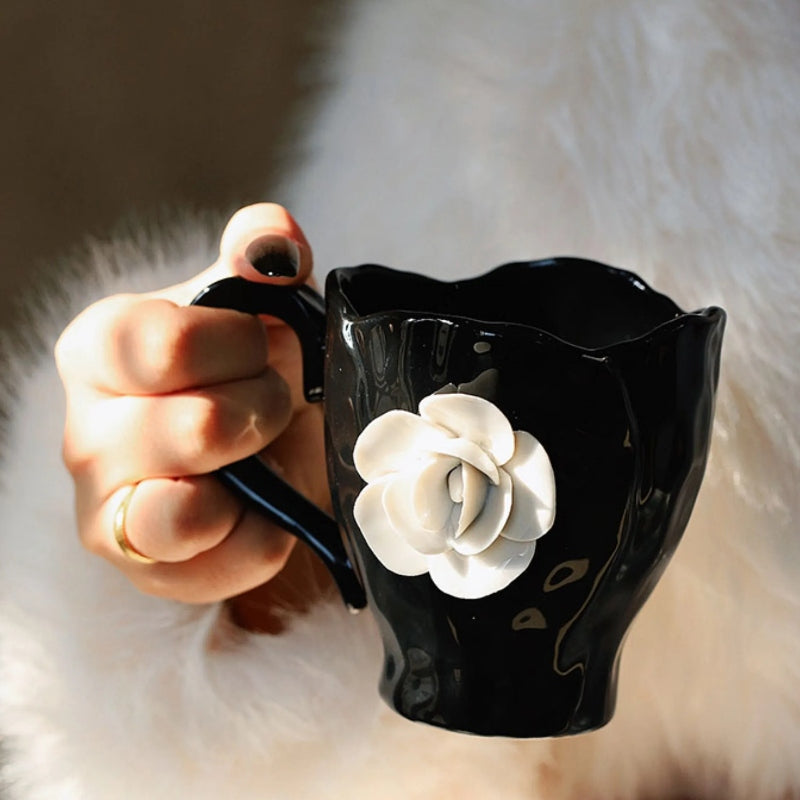 This Camellia Porcelain Cup Set / Mug by Allthingscurated features a single, significant bloom in a timeless black and white design that exudes sophistication. Its high fashion appeal makes it a perfect gift or impressive addition to your high-tea gatherings. Available as a mug or a cup set.