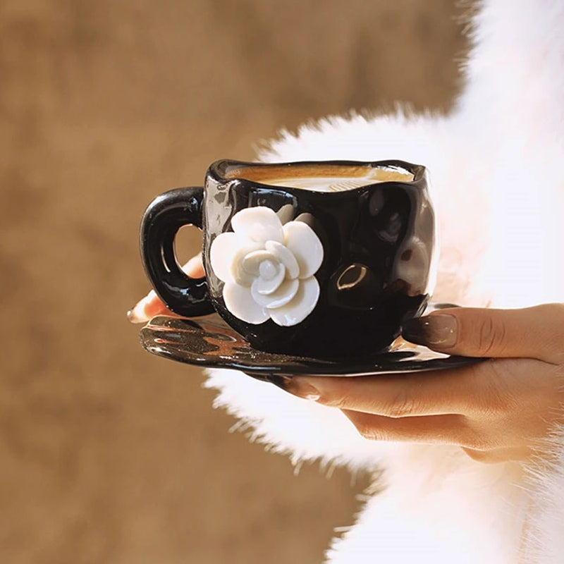 This Camellia Porcelain Cup Set / Mug by Allthingscurated features a single, significant bloom in a timeless black and white design that exudes sophistication. Its high fashion appeal makes it a perfect gift or impressive addition to your high-tea gatherings. Available as a mug or a cup set.