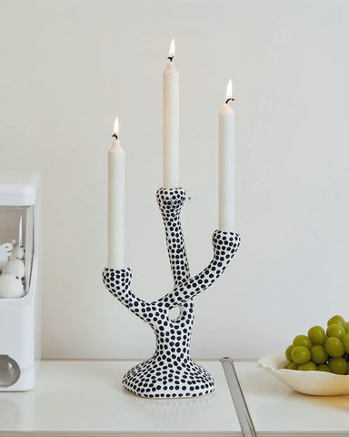 Whimsical Polka Dot Ceramic Candelabra by Allthingscurated combines abstract design with a touch of quirkiness, making it an aesthetically-pleasing piece for any modern and stylish homes. Perfect for lighting up your space with a touch of charm and personality; or as a decorative piece on its own.