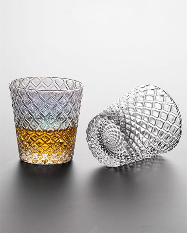 Carven geometric glass tumblers by Allthingscurated spots a unique design resembling the exterior of a pineapple.  An elegant and charming drinkware for serving cocktails, whiskey and sangria to you guests. Come available in clear or iridescent glass with height measuring 7.6cm or 3 inches by top diameter of 7.3cm or 2.8 inches and base diameter of 5.2cm or 2 inches.