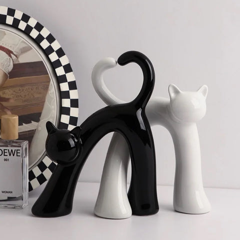 These Cat Couple Love Figurines by Allthingscurated are perfect for cat lovers. Made of ceramic, they feature a pair of cute and whimsical cats in contrasting colors, with their tails entwined to form a heart shape. A romantic and unique gift for any occasion.