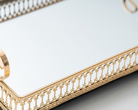 Donatella mirror tray by Allthingscurated showing off its gold-gilded intricate patterns framing the tray with gleaming mirror surface.
