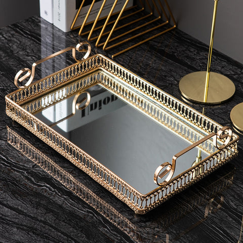 Donatella Mirror tray by Allthingscurated features a mirror surface and intricate gold-gilded pattern surround all sides of the rectangle tray and with 2 handles. Available in small, medium and large size.