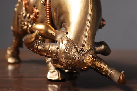 Futurox bull sculpture by Allthingscurated is the embodiment of steampunk aesthetics and futuristic mechanics. This exquisite masterpiece combines the grace and strength of a bull with the intricate beauty of gears. Standing at a height of 13.5cm or 5.3 inches, with length of 22.5cm or 8.8 inches and depth of 10.5cm or 4.1 inches. Its captivating presence will effortlessly elevate any space. Comes in gold and silver.