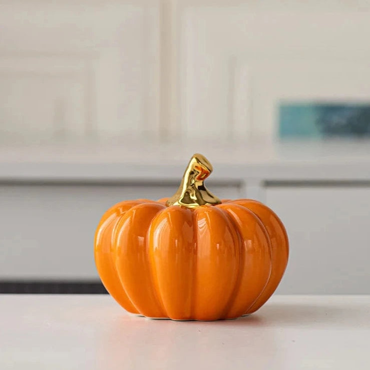 Glazed Ceramic Pumpkins by Allthingscurated spot a sculptural design that are perfect for adding a chic and stylish touch to your Halloween and Thanksgiving celebrations. Available in two designs in orange or white, let these ornamental pumpkins transform your home into a cozy autumn oasis.