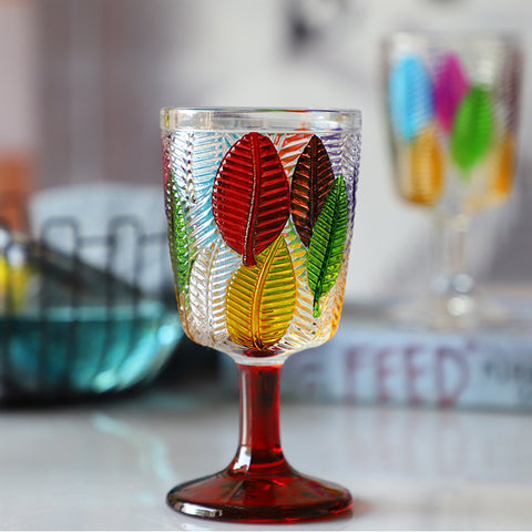 Havana Embossed Leaves Vintage Goblets by Allthingscurated, featuring contrasting multi-colored leaves embossed onto lead-free glass vessel. Charming with a touch of vintage vibe.