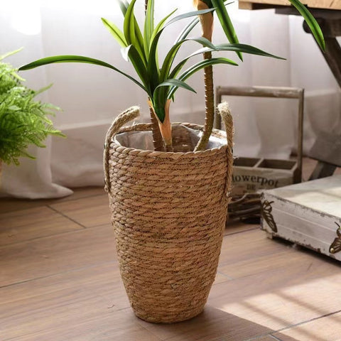 Hayden Tall Planters by Allthingscurated come in 3 sizes. Hand-woven using natural seagrass and comes with handles for easy transportation.