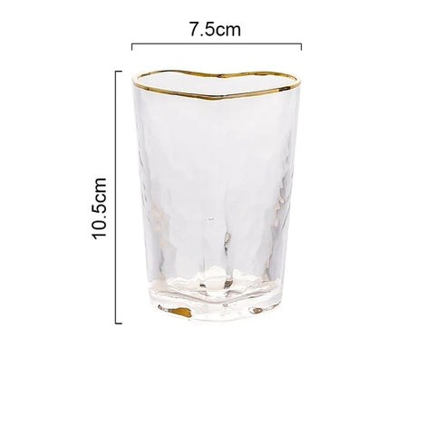 Heart Shape Tumbler by Allthingscurated is a stylish addition to any table. Made of glass and spots a unique, stylish heart-shaped design with an elegant gold rim and hammered pattern. Versatile for everyday use or as a special gift to show your love on Valentine’s Day.