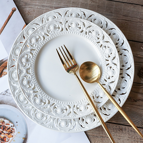 Juliette White Lace Dinnerware by Allthingscurated adds an elegant touch to your tabletop. This sophisticated set is crafted out of ceramic with a beautiful embossed lace rim, giving it a vintage touch.  The creamy white pieces come in a dinner plate and cake stand in 2 sizes for easy mixing and matching. They are perfectly sized for a main course, starters and desserts.