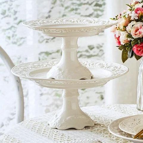 Juliette White Lace Dinnerware by Allthingscurated adds an elegant touch to your tabletop. This sophisticated set is crafted out of ceramic with a beautiful embossed lace rim, giving it a vintage touch.  The creamy white pieces come in a dinner plate and cake stand in 2 sizes for easy mixing and matching. They are perfectly sized for a main course, starters and desserts.