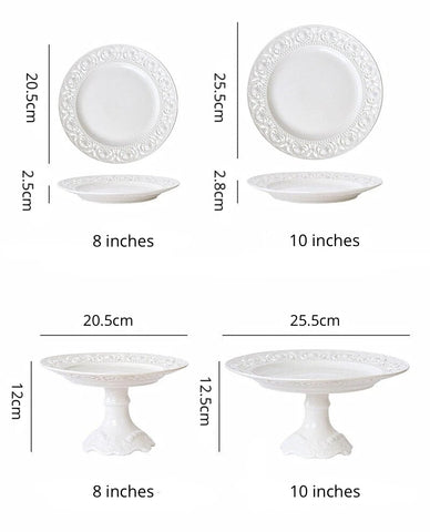 Juliette White Lace Dinnerware by Allthingscurated adds an elegant touch to your tabletop. This sophisticated set is crafted out of ceramic with a beautiful embossed lace rim, giving it a vintage touch.  The creamy white pieces come in a dinner plate and cake stand in 2 sizes for easy mixing and matching. They are perfectly sized for a main course, starters and desserts.