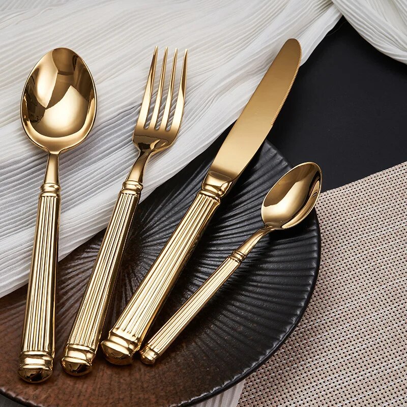 Julius Gold Stainless Steel Flatware Sets by Allthingscurated are crafted from high-quality 18/10 stainless steel. The weighty and solid construction provides a luxurious feel, while the Roman column handle design adds a touch of elegance. The mirror polished surface reflects a bright and shiny finish, adding a touch of sophistication to any table.