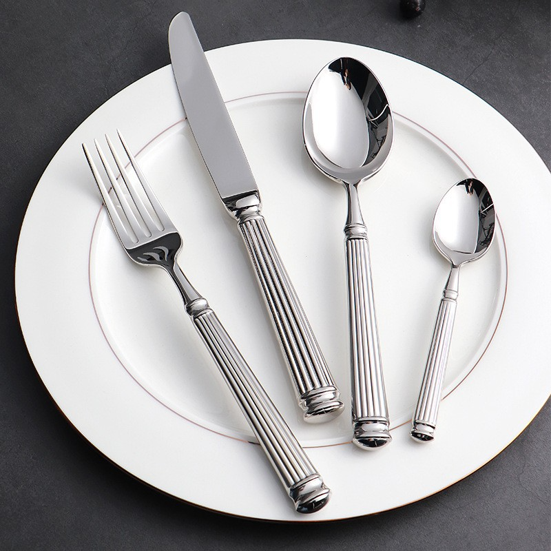 Julius Silver Stainless Steel Flatware Sets by Allthingscurated are crafted from high-quality 18/10 stainless steel. The weighty and solid construction provides a luxurious feel, while the Roman column handle design adds a touch of elegance. The mirror polished surface reflects a bright and shiny finish, adding a touch of sophistication to any table.