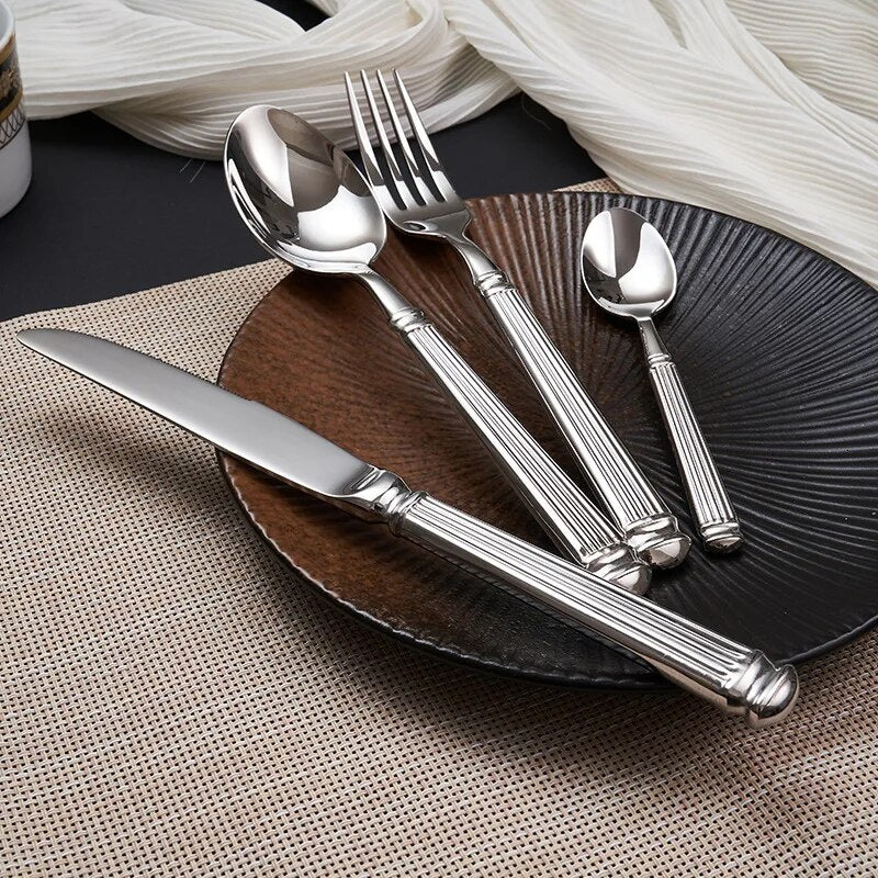 Julius Silver Stainless Steel Flatware Sets by Allthingscurated are crafted from high-quality 18/10 stainless steel. The weighty and solid construction provides a luxurious feel, while the Roman column handle design adds a touch of elegance. The mirror polished surface reflects a bright and shiny finish, adding a touch of sophistication to any table.