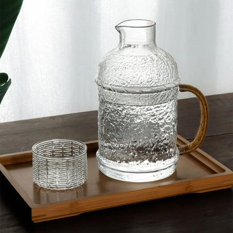 Kiv Hammered Glass Pitcher with Cover in 2 liter or 68 ounce capacity by Allthingscurated. Comes with a hemp rope handle for a rustic vibe. Large capacity and heat-resistant. It's the perfect thirst quencher for summer.