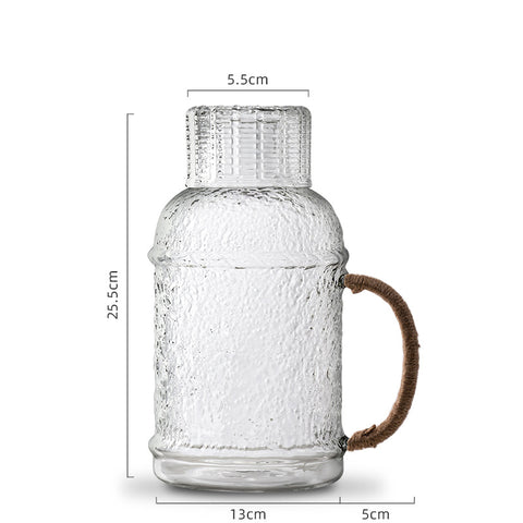 Kiv Hammered Glass Pitcher with Cover in 2 liter or 68 ounce capacity by Allthingscurated. Comes with a hemp rope handle for a rustic vibe. Large capacity and heat-resistant. It's the perfect thirst quencher for summer.