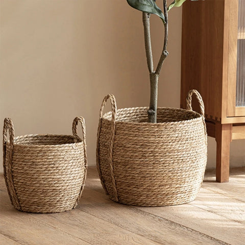 Leedon Woven Baskets by Allthingscurated are hand-woven from seagrass which is an eco-friendly material. The baskets feature sturdy handles for easy transportation and lend a rustic charm to any space. Perfect for storing household items or displaying your favorite plants. Available in 3 sizes.