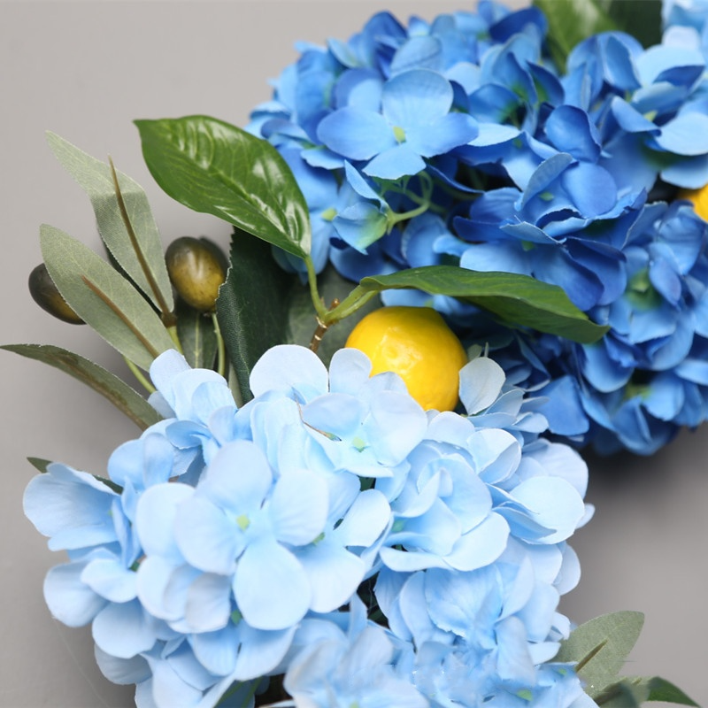 Summer Lemon Hydrangea wreath by Allthingscurated features a vibrant and cheerful yellow and blue color scheme, evoking images of sunny blue skies and warm summer days. The wreath adds a pop of color to your door and bring a little extra happiness to your home.