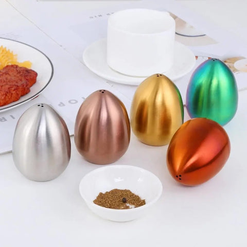 Introducing Metallic Egg Shape Salt and Pepper Shaker by Allthingscurated. This shaker is crafted from stainless steel and comes in 5 delightful colors. Perfect for Easter celebrations and as a housewarming gift. It will add a touch of playfulness to your dining table and spice up your meals with a little humor.