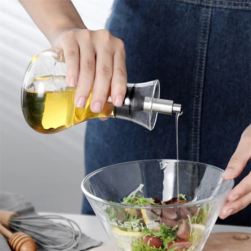 Glass Bottle Oil Dispensers by Allthingscurated spot a streamlined design with leak-proof silicone nozzle that ensure easy and mess-free pouring and drizzling. Comes with a cover to keep contents fresh and free from dust. Comes in large and small bottle that are just perfect for drizzling over salads or using in daily cooking.