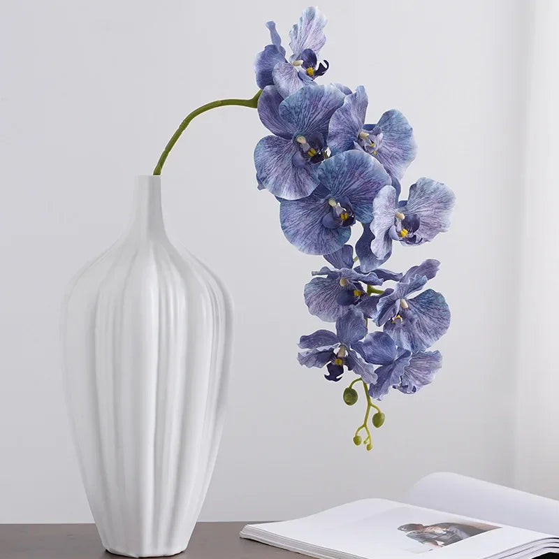 Silk Phalaenopsis Orchids by Allthingscurated feature dynamic blooms with vivid details and texture that will add a touch of understated elegance and charm to your living space. These graceful beauties come in 5 mesmerizing colors.