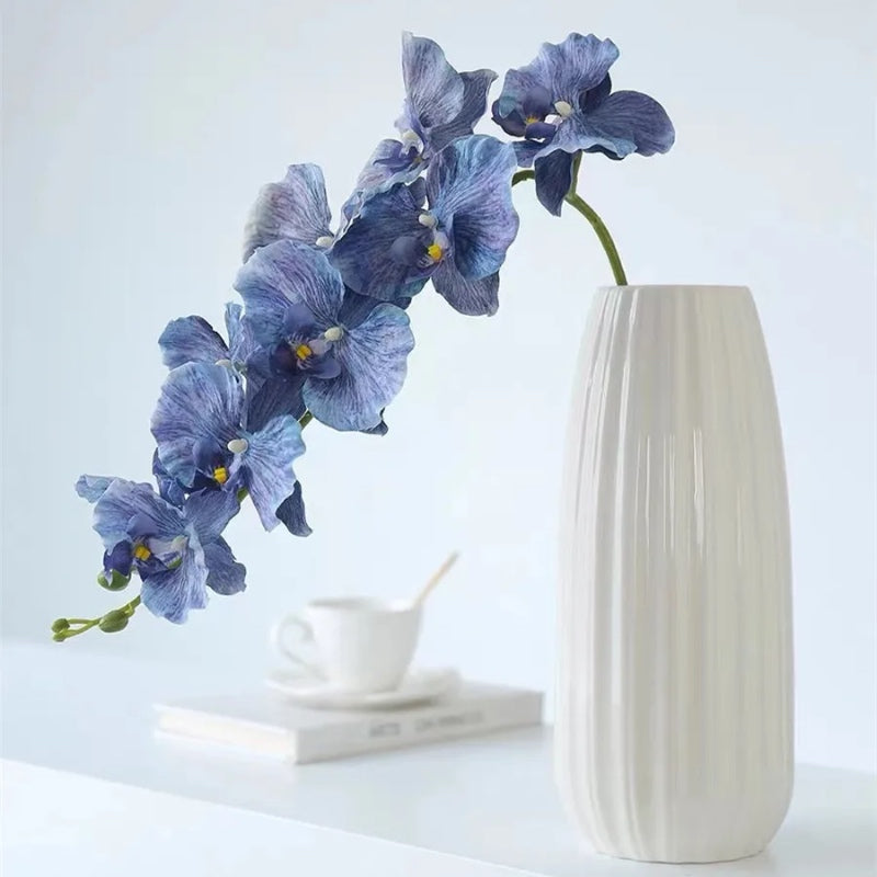 Silk Phalaenopsis Orchids by Allthingscurated feature dynamic blooms with vivid details and texture that will add a touch of understated elegance and charm to your living space. These graceful beauties come in 5 mesmerizing colors.