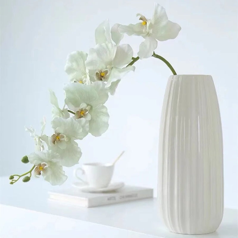 Silk Phalaenopsis Orchids by Allthingscurated feature dynamic blooms with vivid details and texture that will add a touch of understated elegance and charm to your living space. These graceful beauties come in 5 mesmerizing colors.